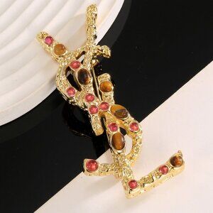 Saint Laurent brooches